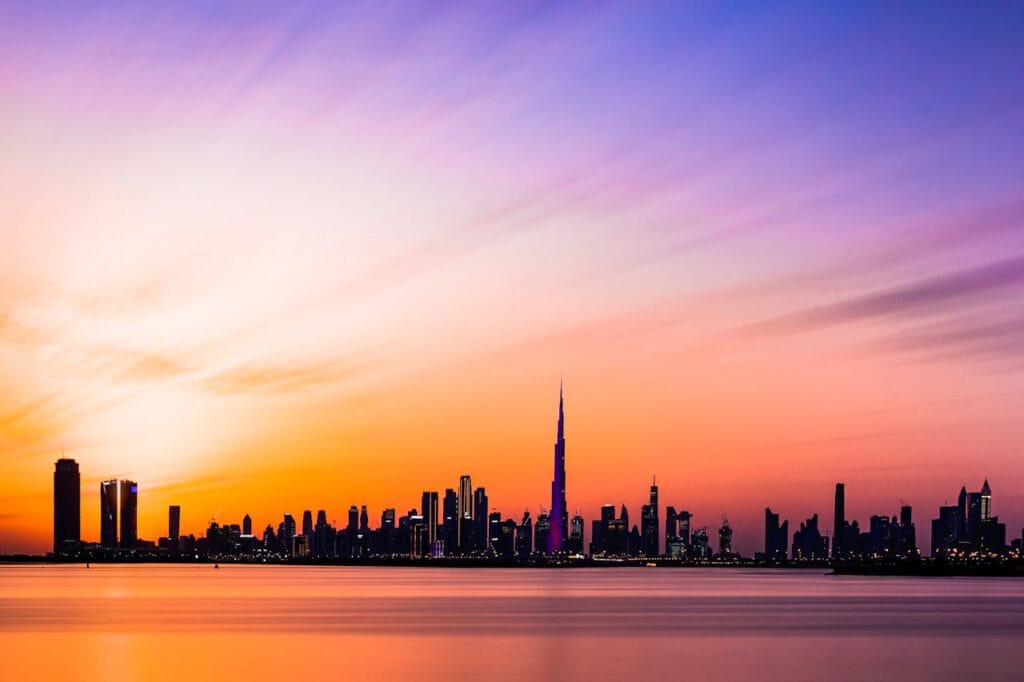Home 3 Beautiful view of the Dubai skyline featuring Burj Khalifa during a colorful sunset.